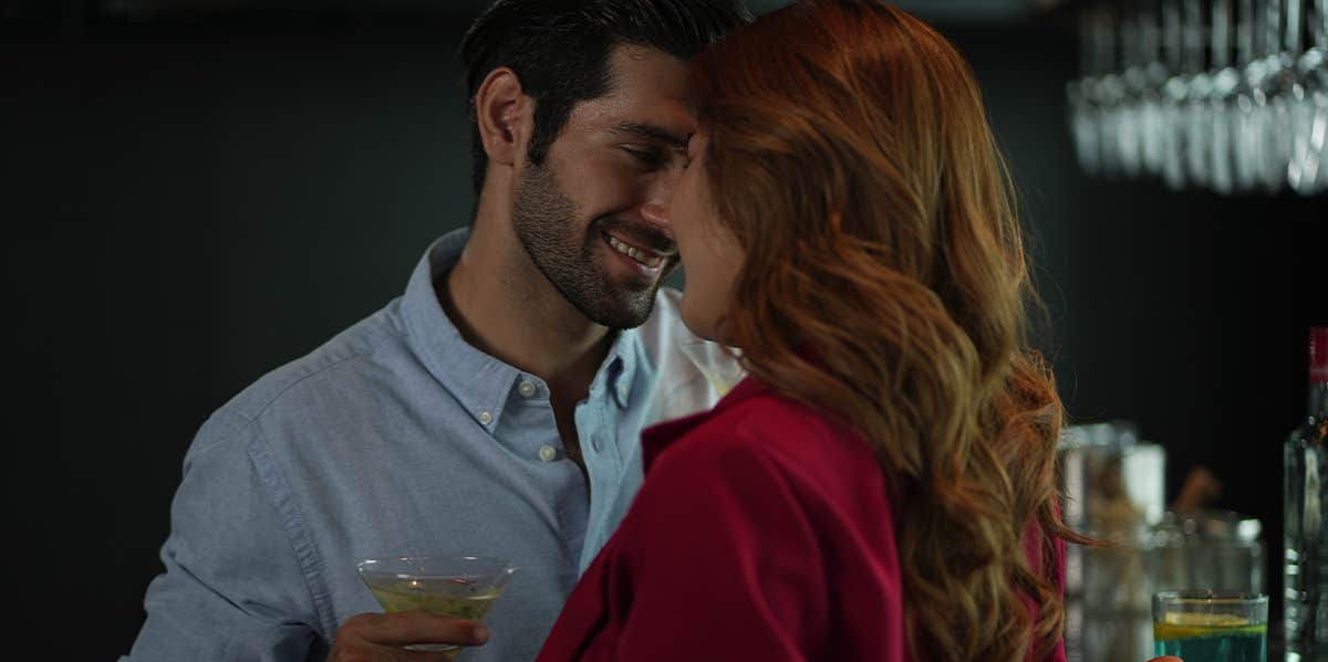 man flirting with woman at bar