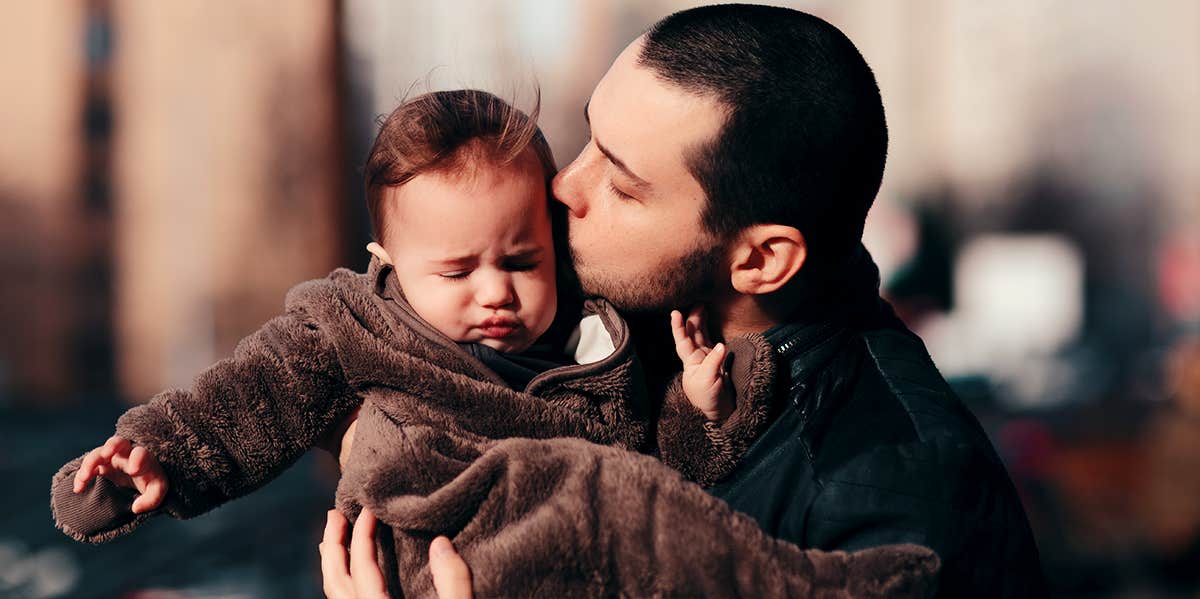 upset baby with father