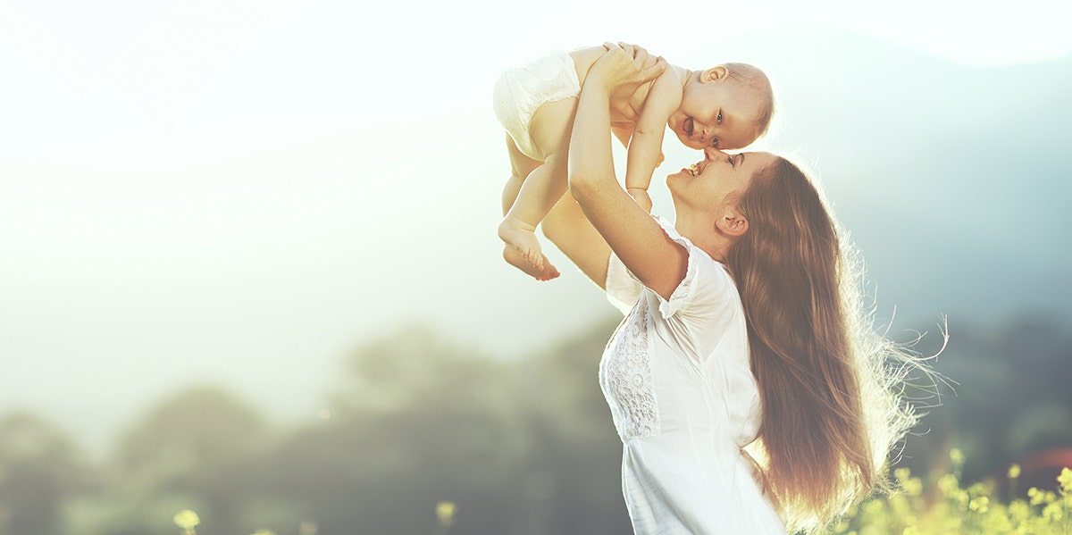 woman kissing baby