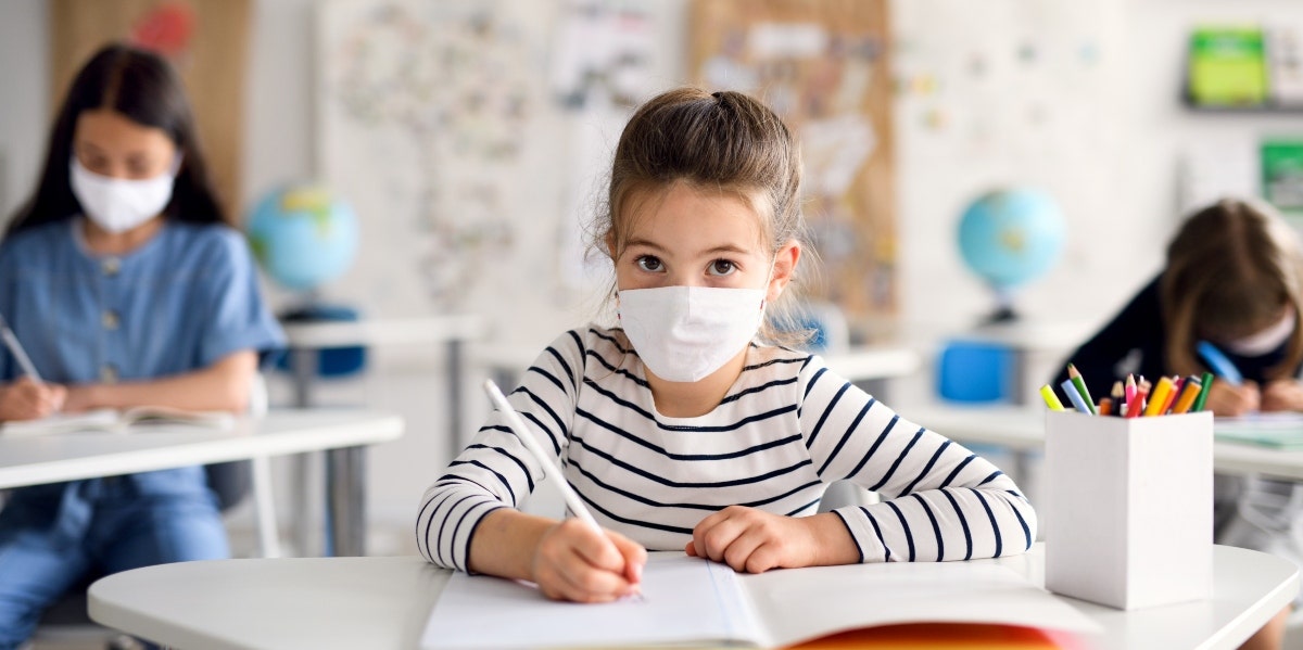 back to school tips girl wearing mask in classroom
