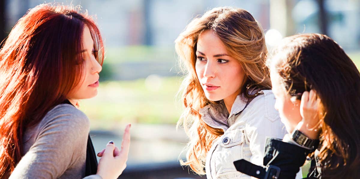 Bad mouthing ex Three women in conversation outside