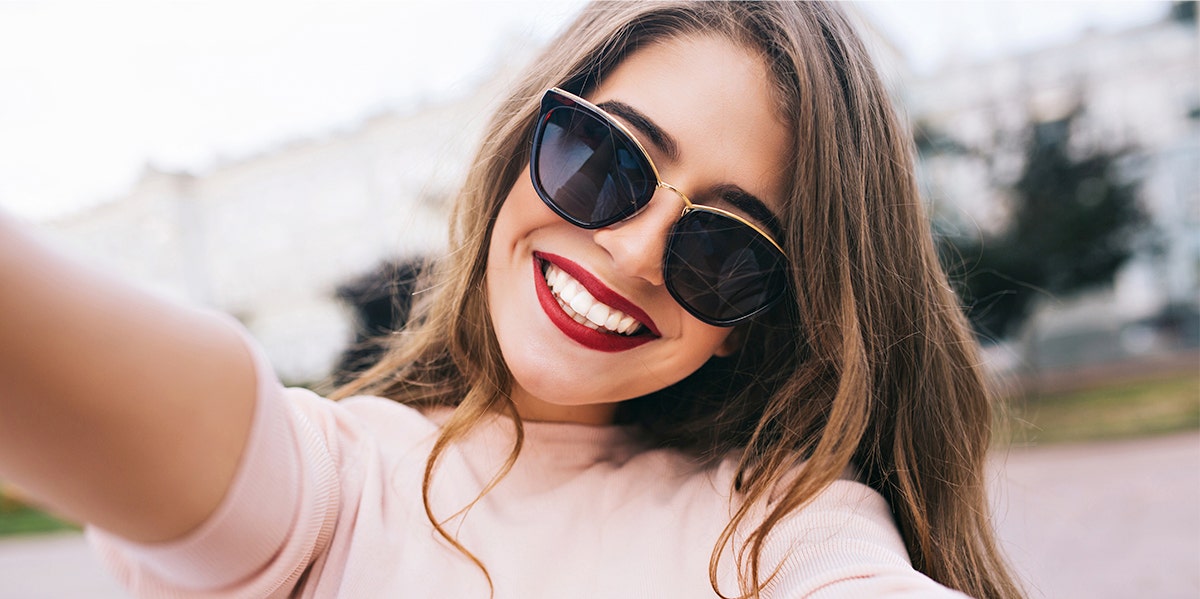 woman smiling with sunglasses