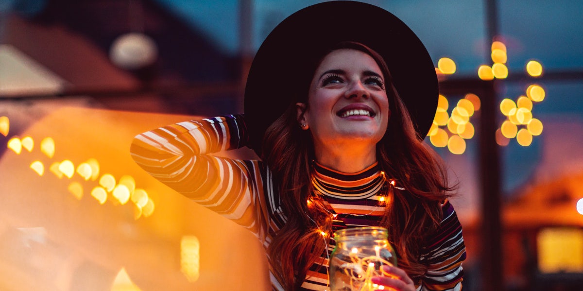 woman with light wearing big brimmed hat