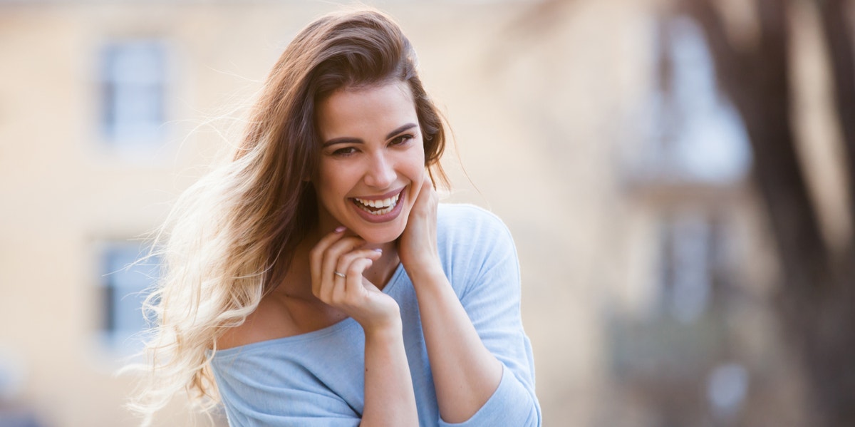 woman with chin in hands smiling