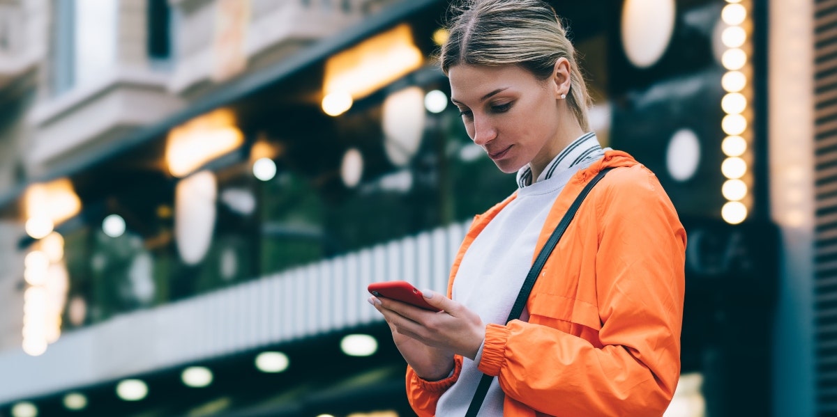 confident woman looking at her phone