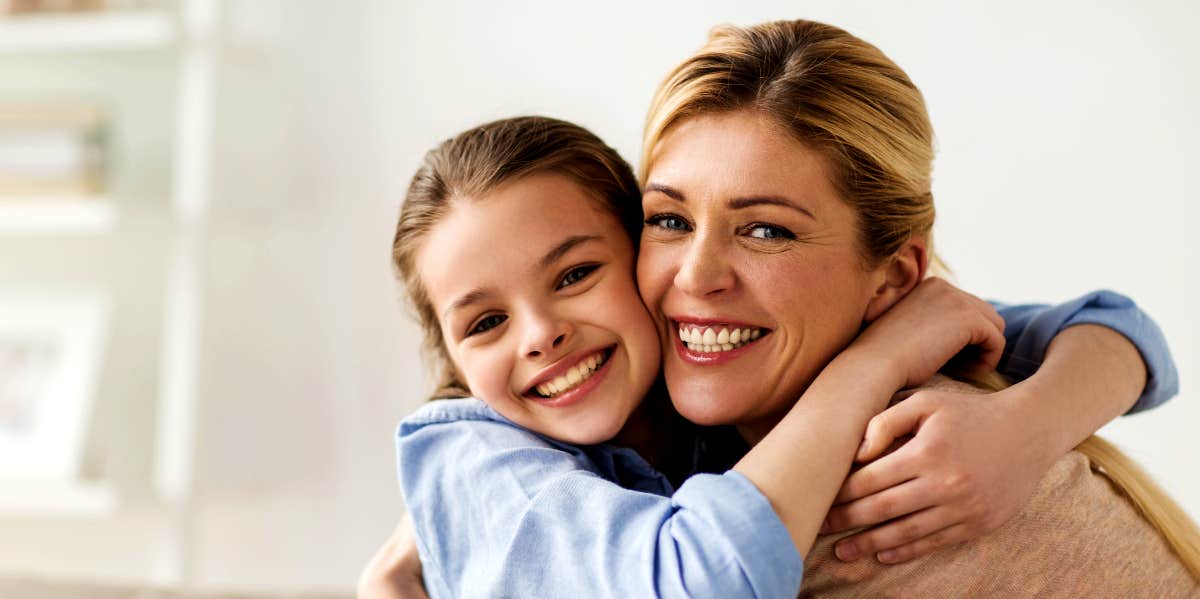 Mom hugging daughter