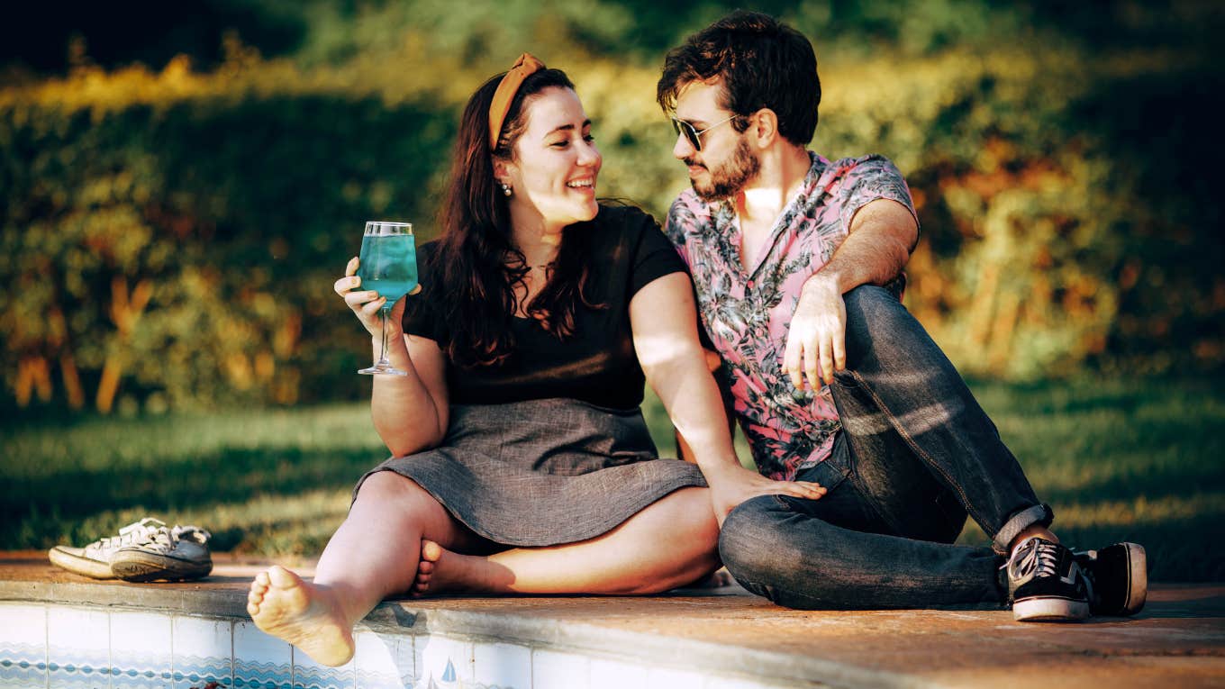 couple talking by the poolside