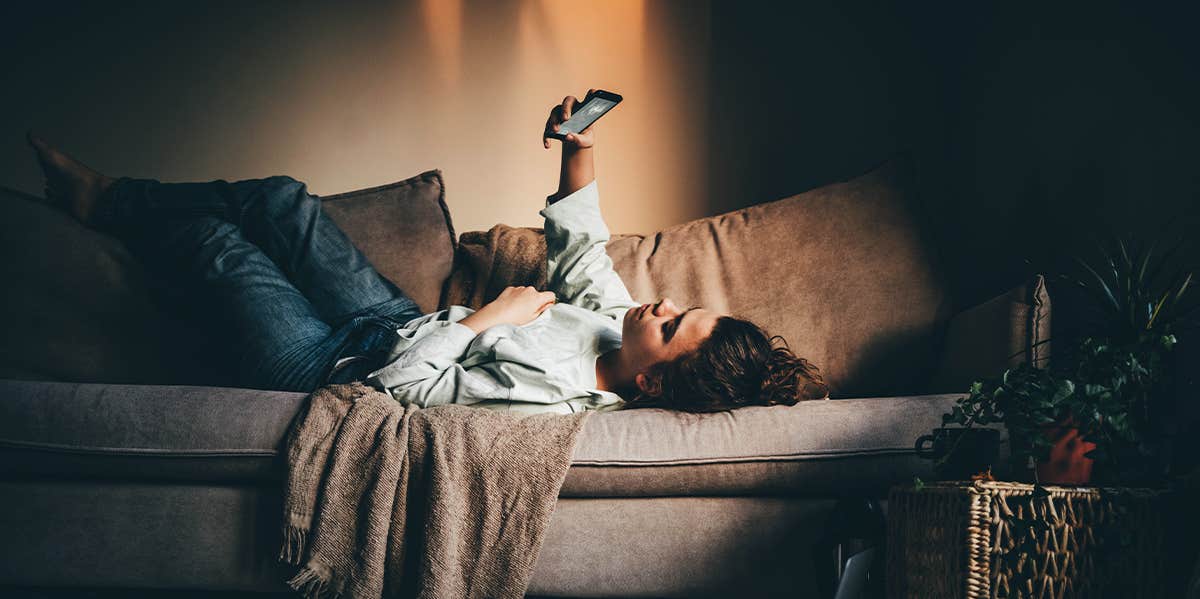 woman laying on couch at home