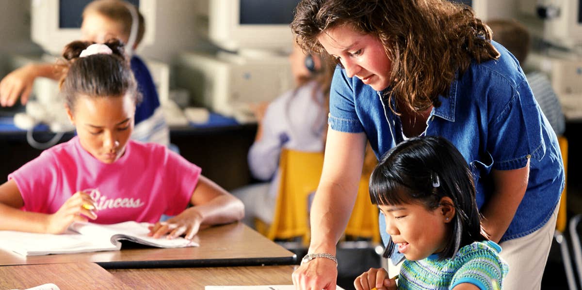 teacher helping a student