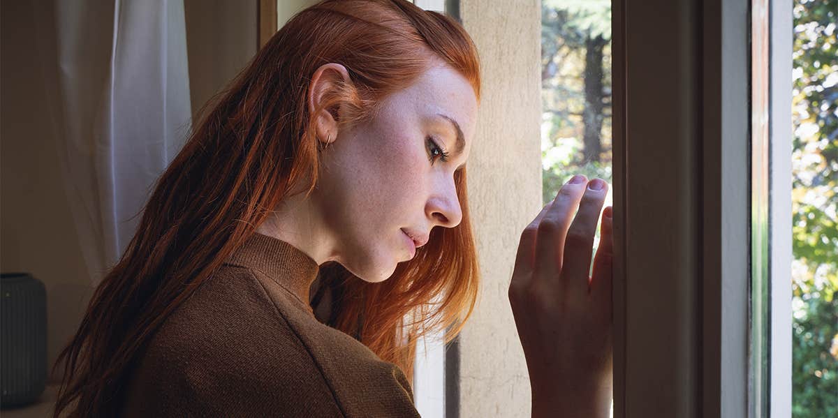 lonely woman by window