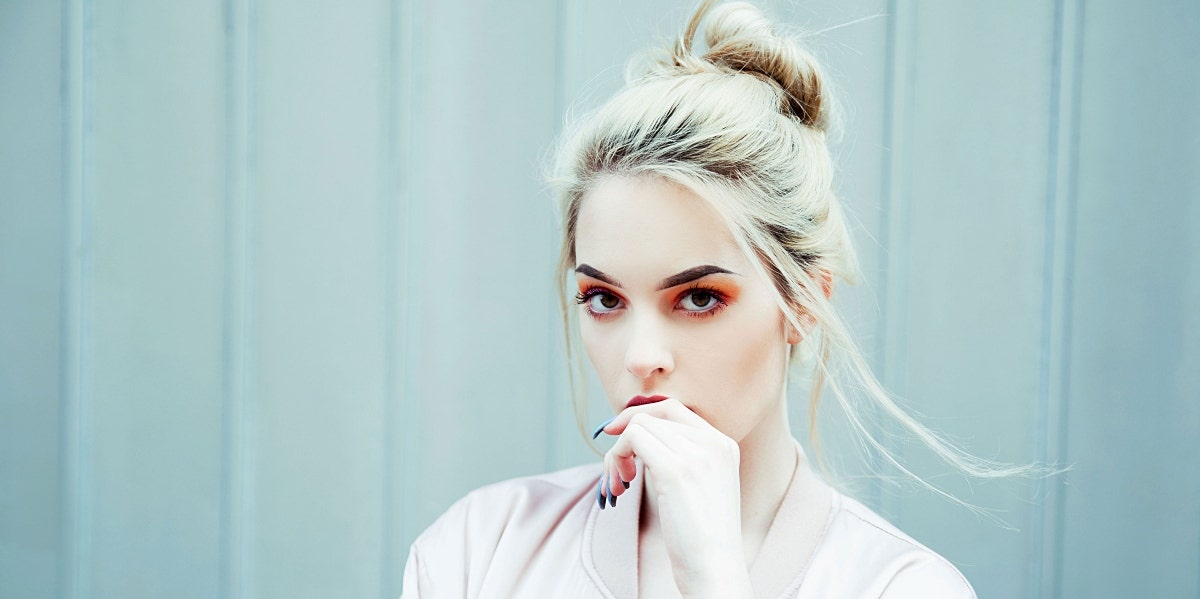 benefits of zinc woman with hand at her lips