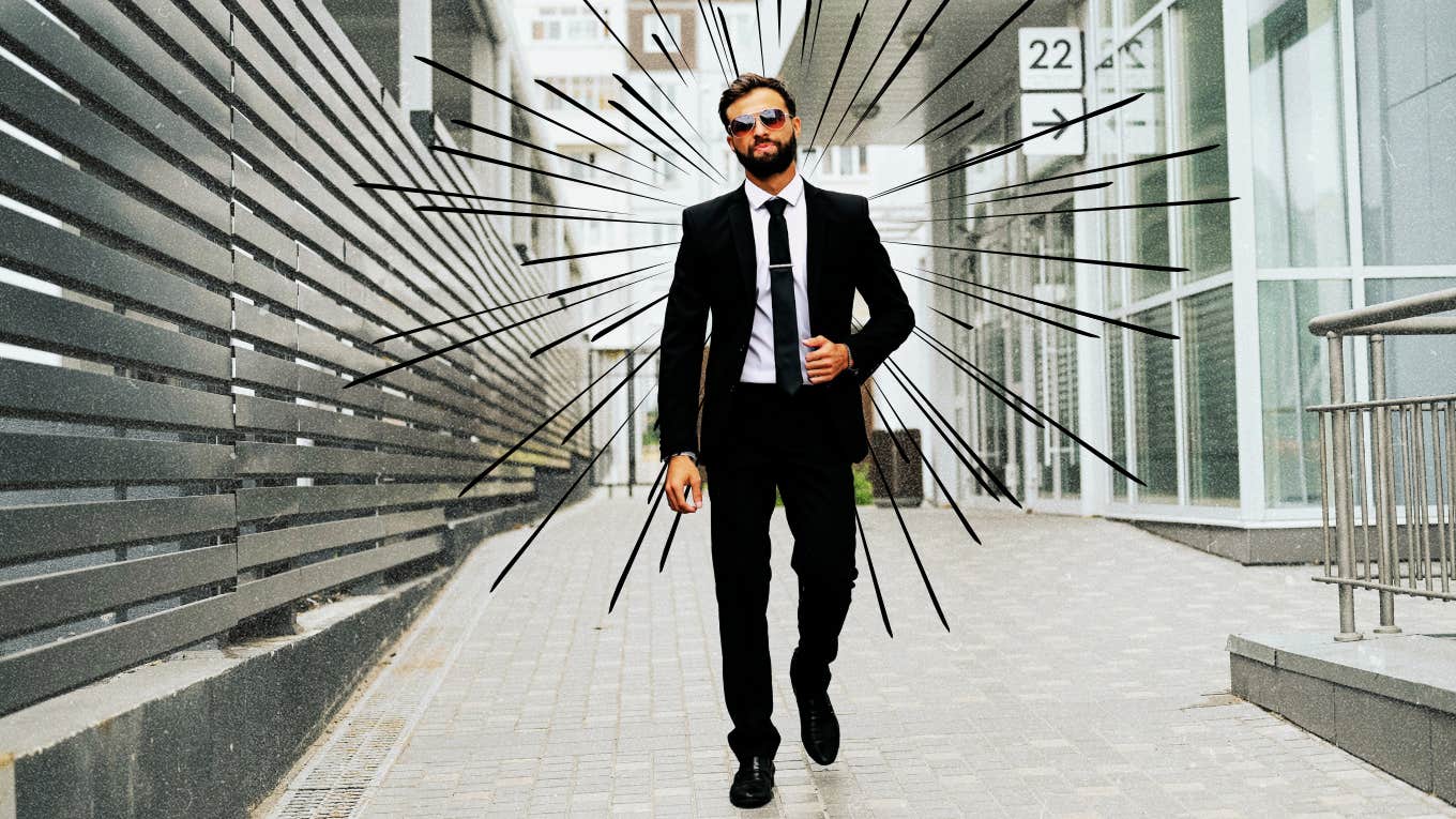 Man in suit walking away from buildings