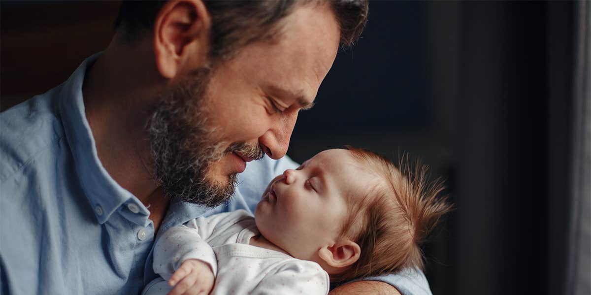 father holding newborn baby