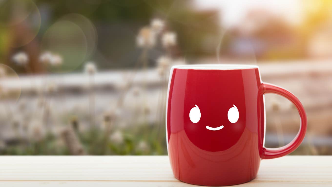 Why November 15 Horoscopes Are So Good For 3 Zodiac Signs a smiling face on a red mug