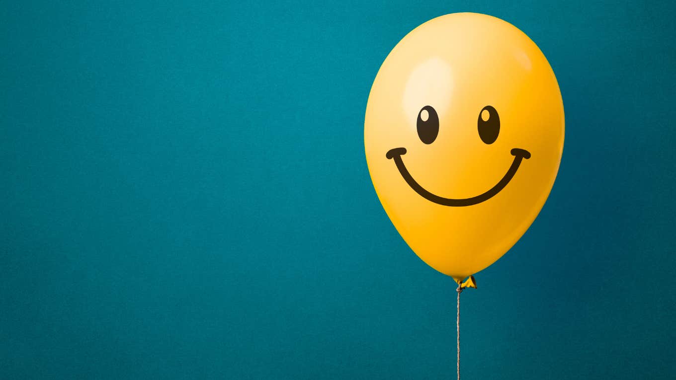 smiley face on yellow balloon