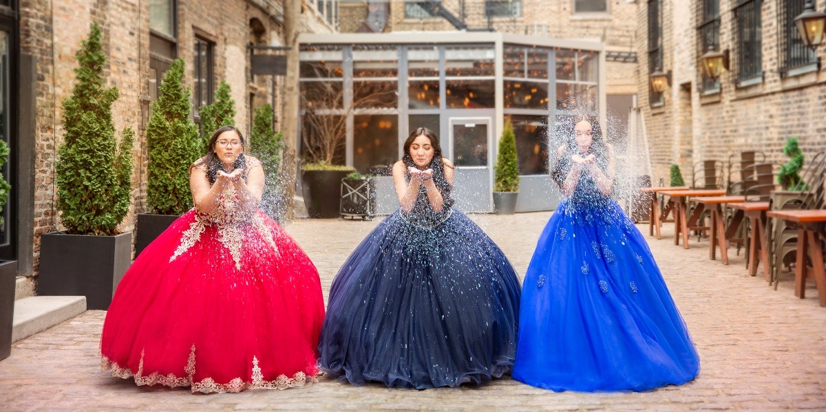 three girls wearing quince gowns