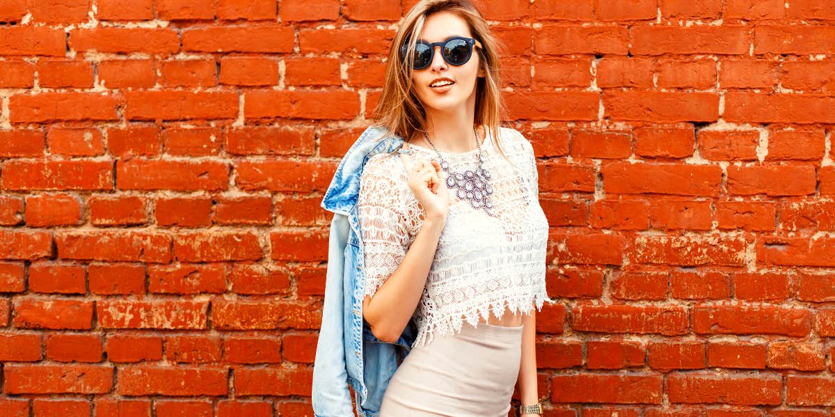 woman in front of a brick wall