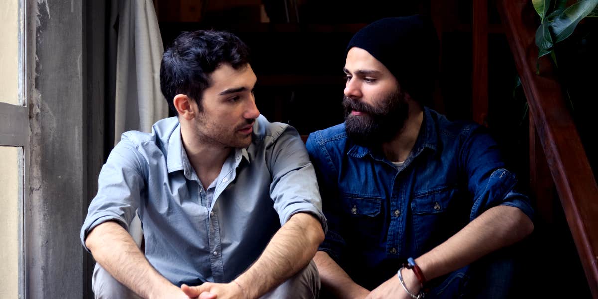 two men talking about feelings on stairs