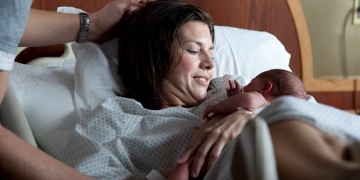 woman holding newborn baby