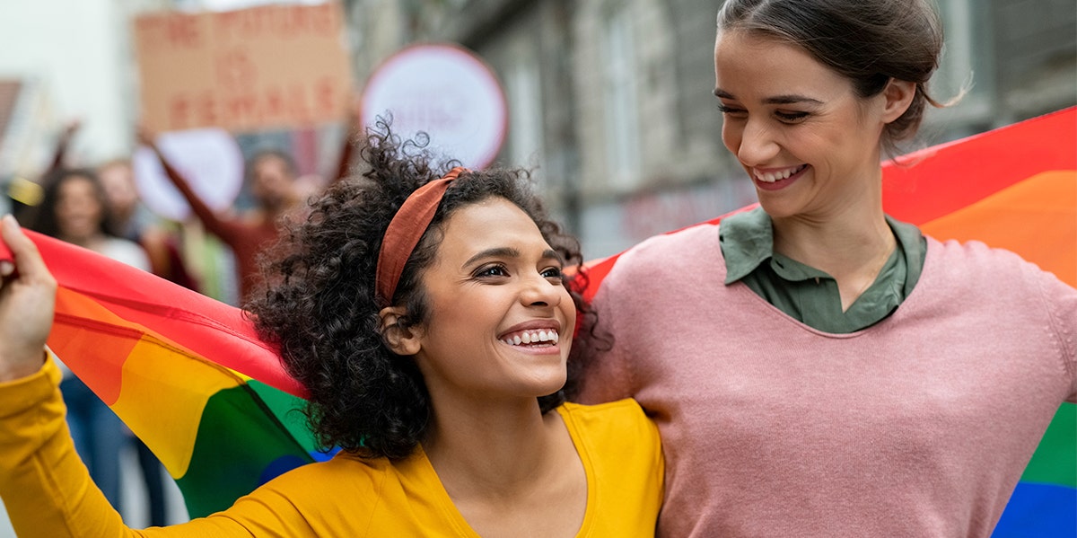 couple draped in an lgbt flag