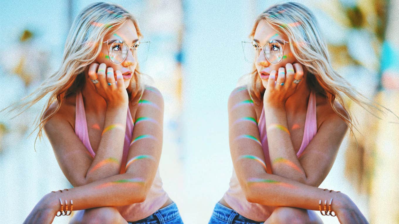 Woman sitting outside with hand on face 