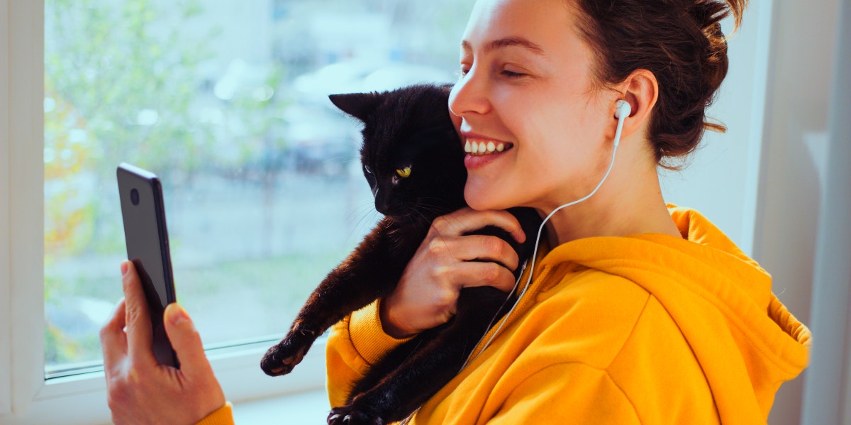 woman holding black cat