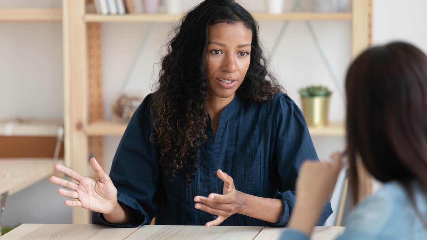 close up of black employee having meeting with co-worker in office