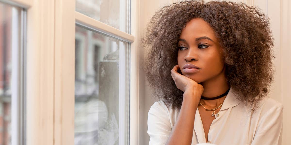 Woman looking out window