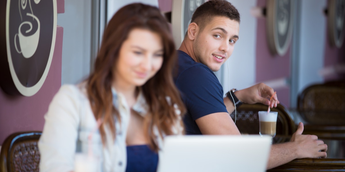 guy checking out woman at cafe