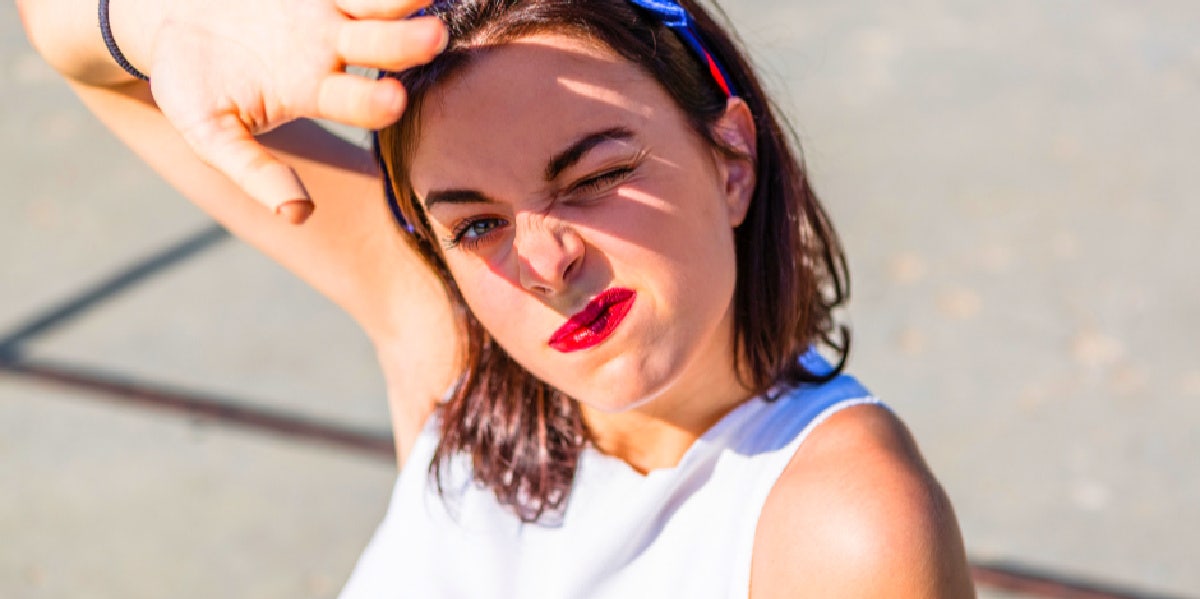 girl blocking the sun from her eyes