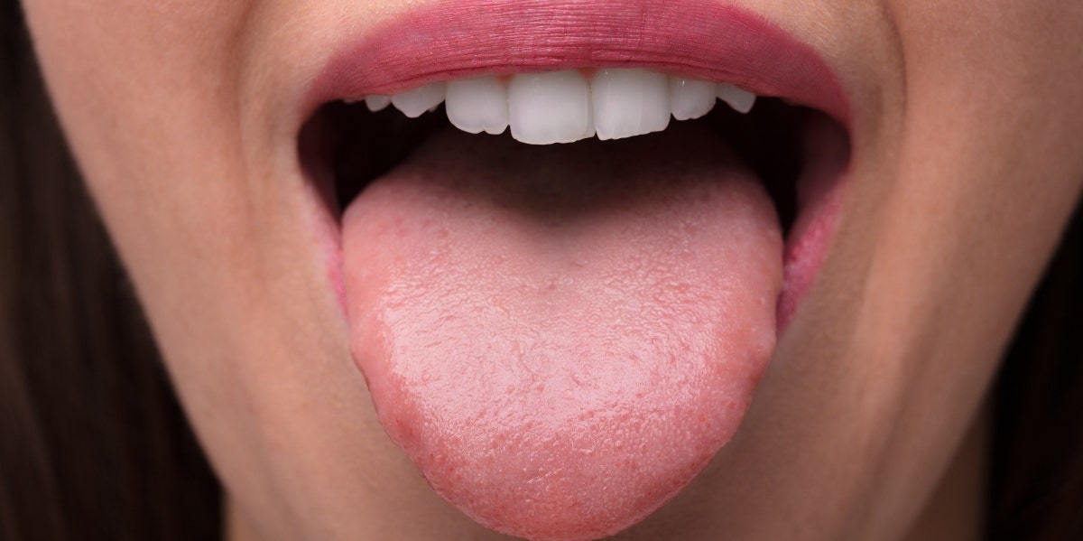 closeup of woman's mouth with her tongue out