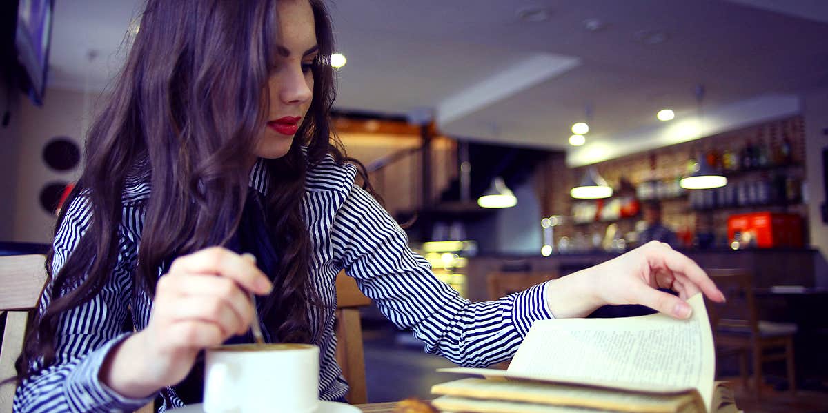 woman at coffee shop reading book