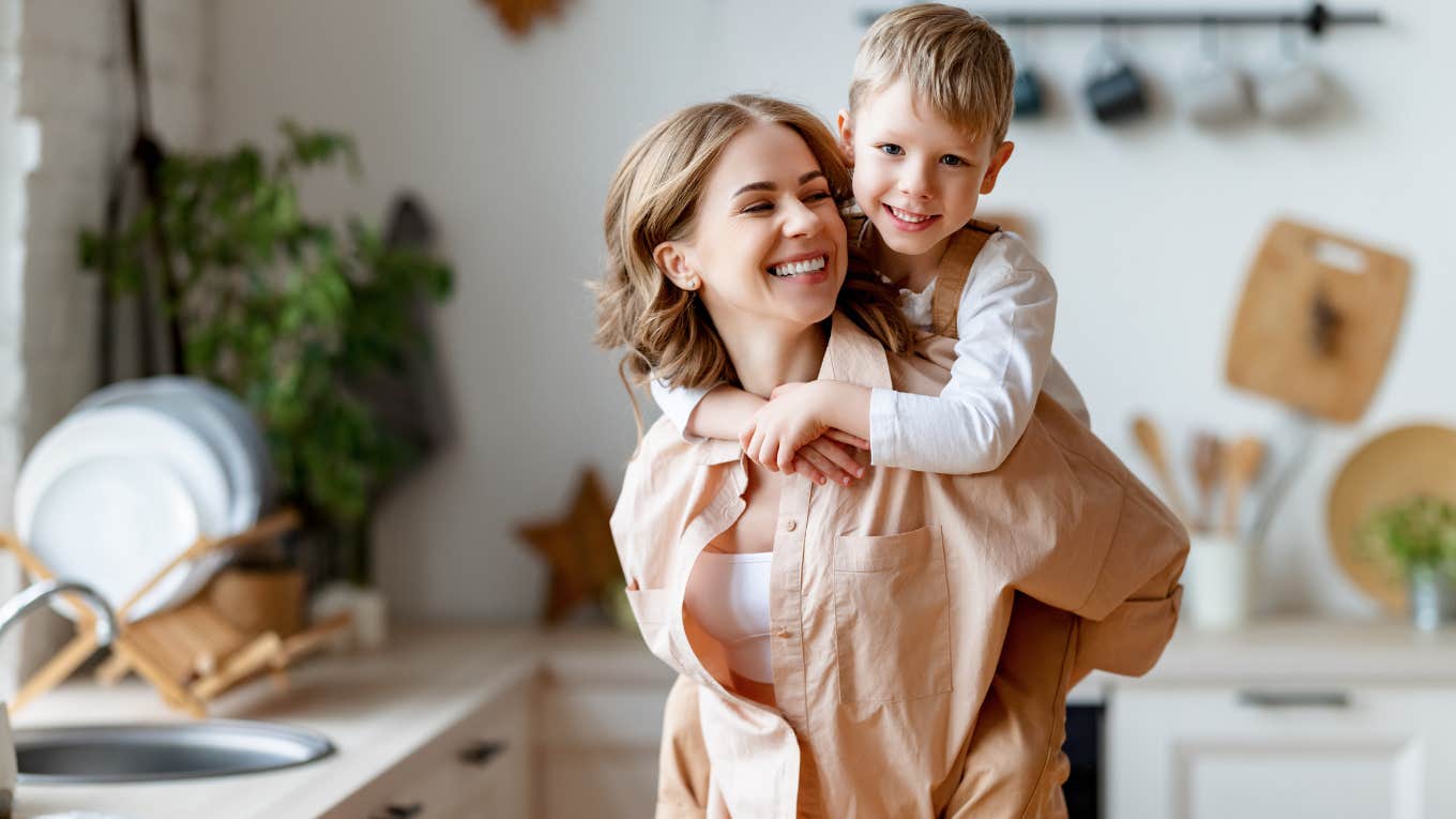 Mother holding her young son and smiling