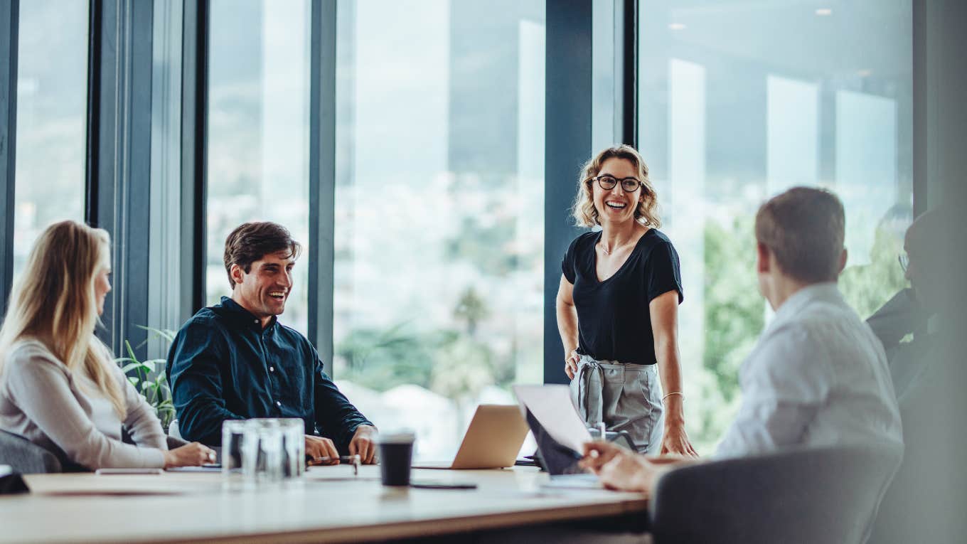 Office colleagues having casual discussion during meeting in conference room.