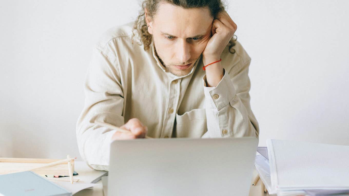 frustrated man looking at laptop