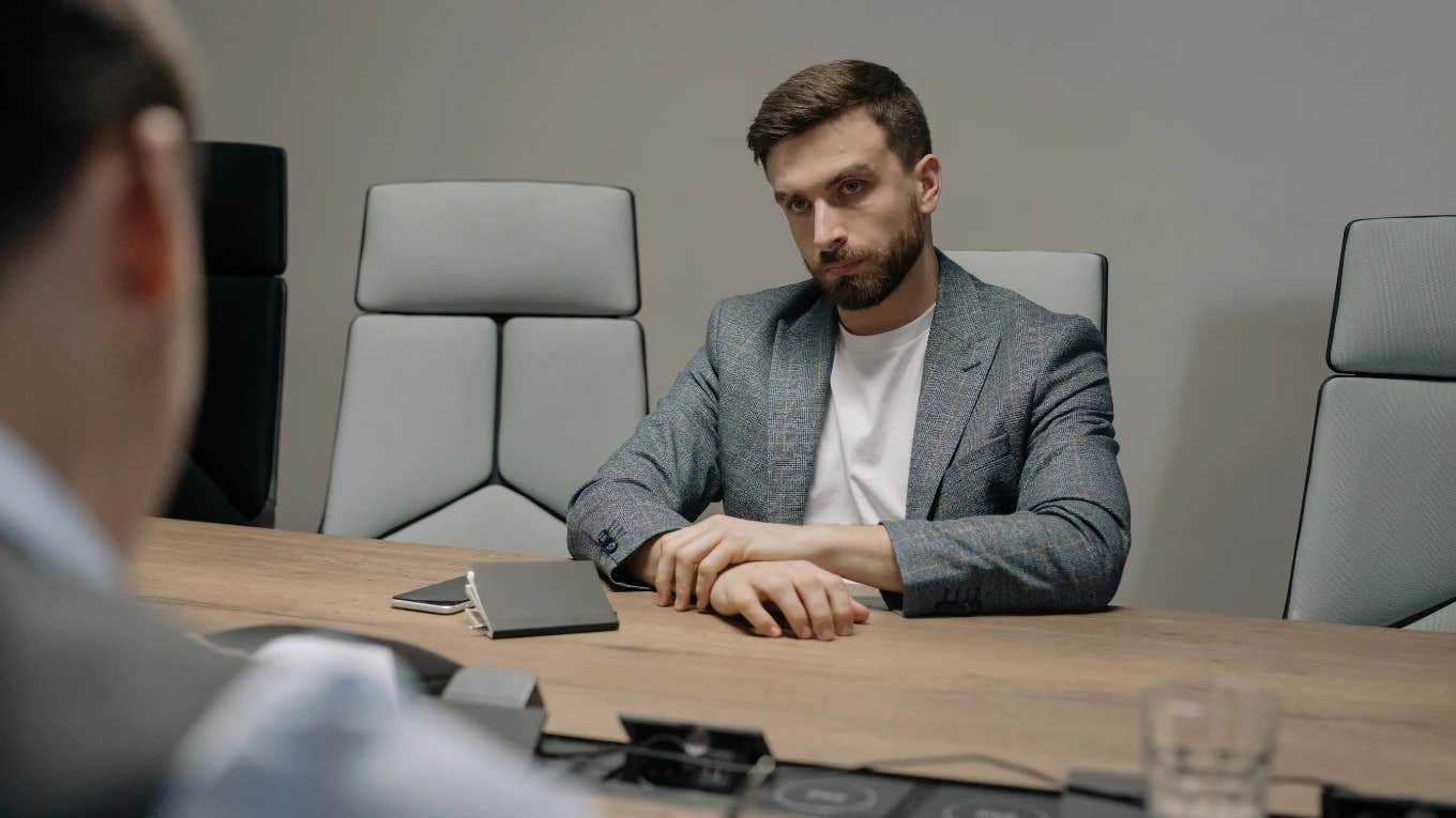 Boss Refuses To Accept Worker’s Two-Week Notice Because Finding A Replacement Would Take Too Long employee sitting at conference table