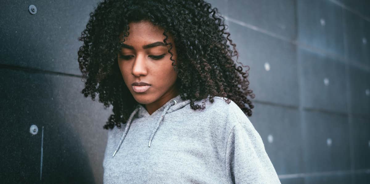 Boss Shares Woman's Mental Health Condition With Her Coworkers. sad woman looking down