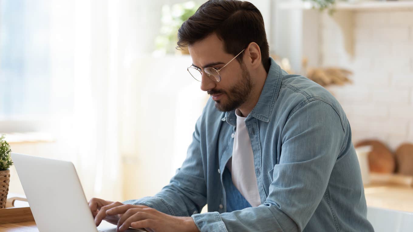 man working on laptop at home