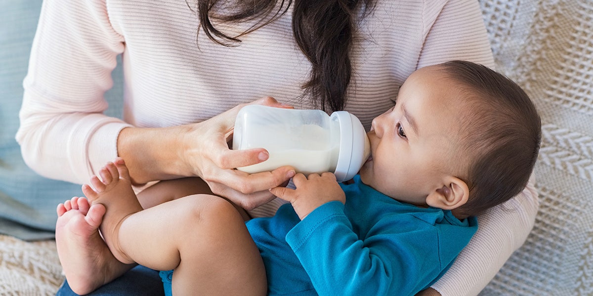 woman feeding son formula