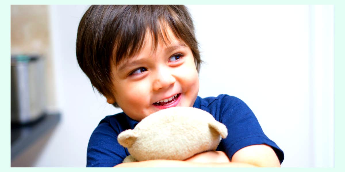 Boy cuddling a toy