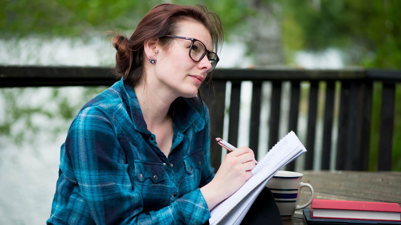 Woman writing notes in notebook 