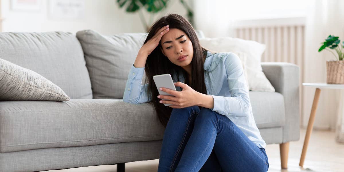 Woman sad looking at phone