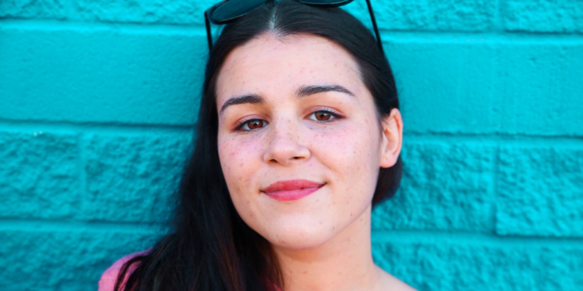 woman with brown eyes smirking