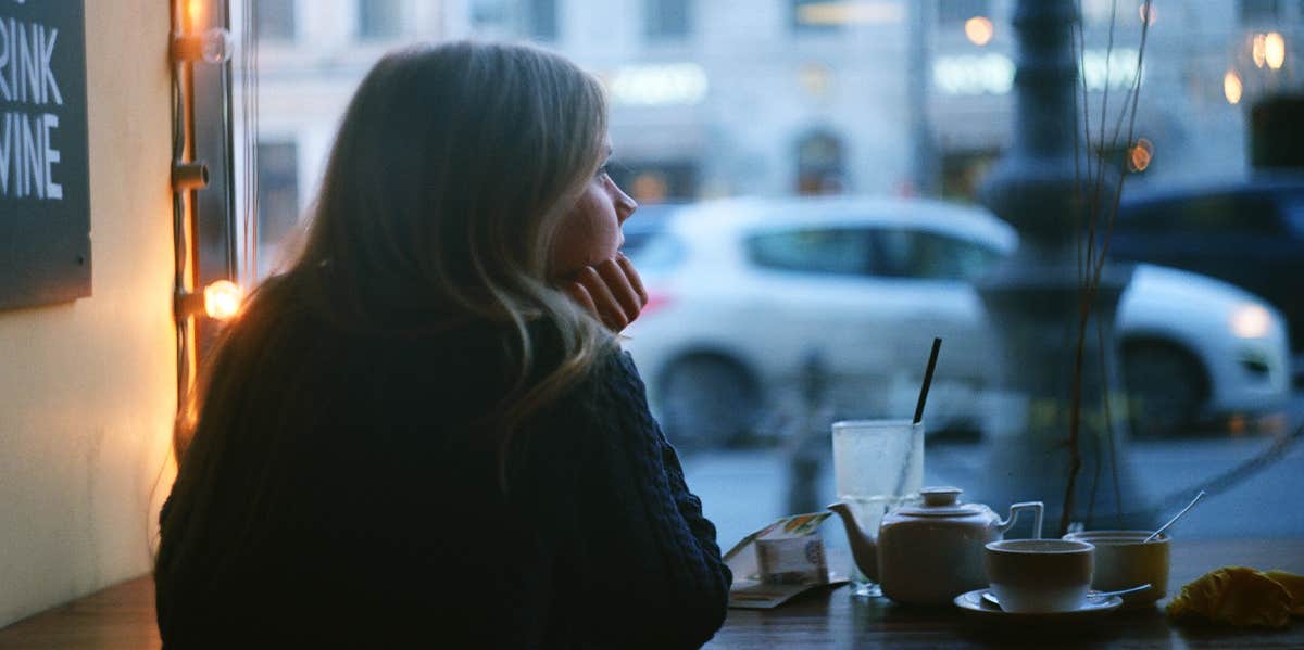 sad woman at coffee shop