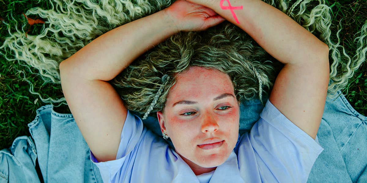Breast Massages May Prevent Cancer, Says Study woman laying in grass