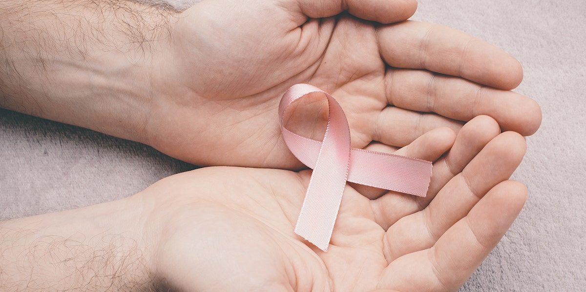 woman holding breast cancer pin