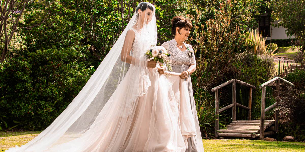 bride walking down the aisle with mother