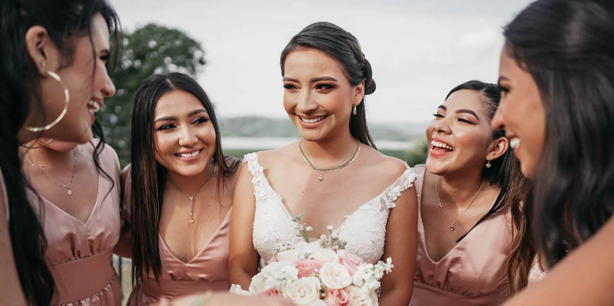 bride standing with bridesmaid