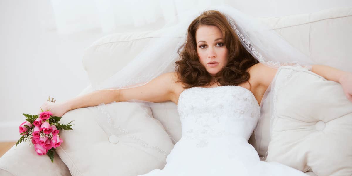 bride relaxing on white couch