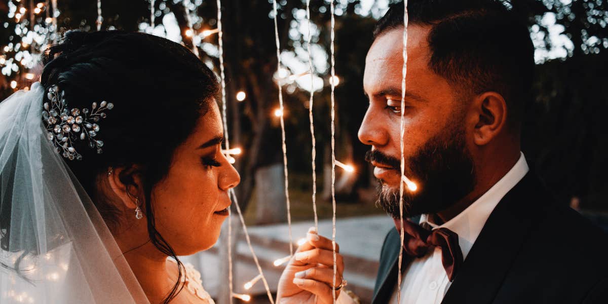 Bride and groom under fairy lights